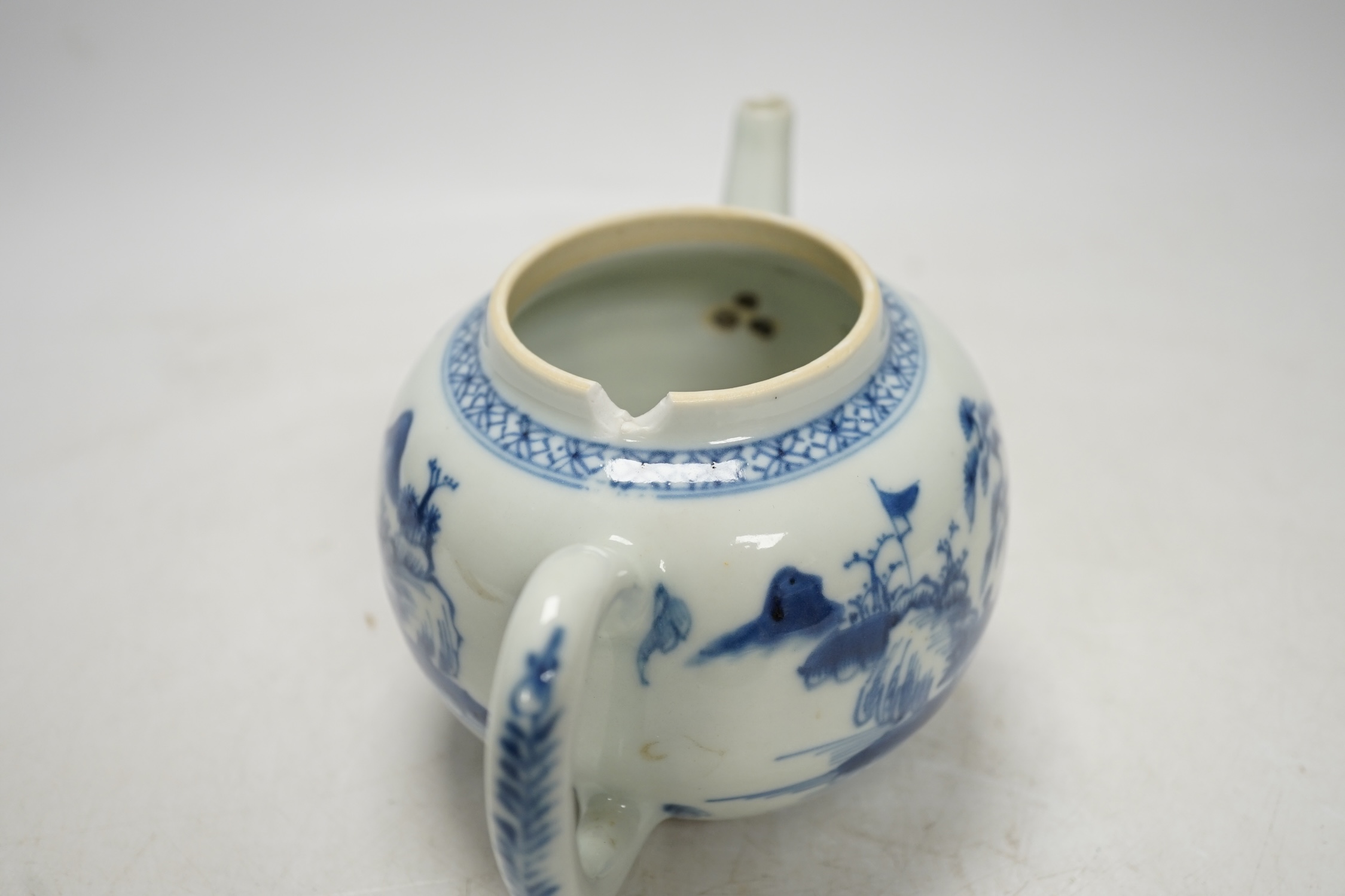 An 18th century Chinese blue and white teapot and cover, 12cm high. Condition - poor